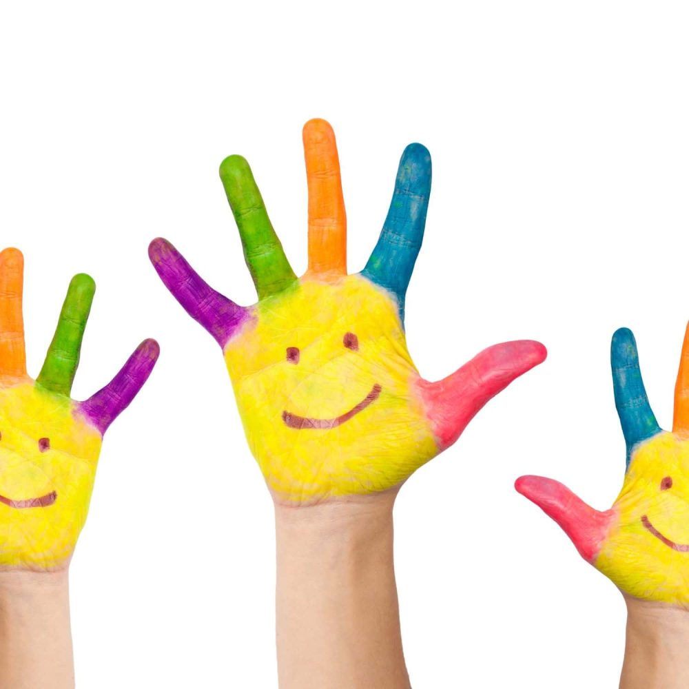 Colourful hand-painted children's hands with smiley faces for online safety training.