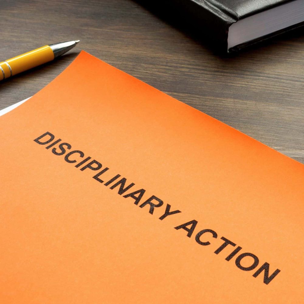 Disciplinary Procedures Training Course document on desk.