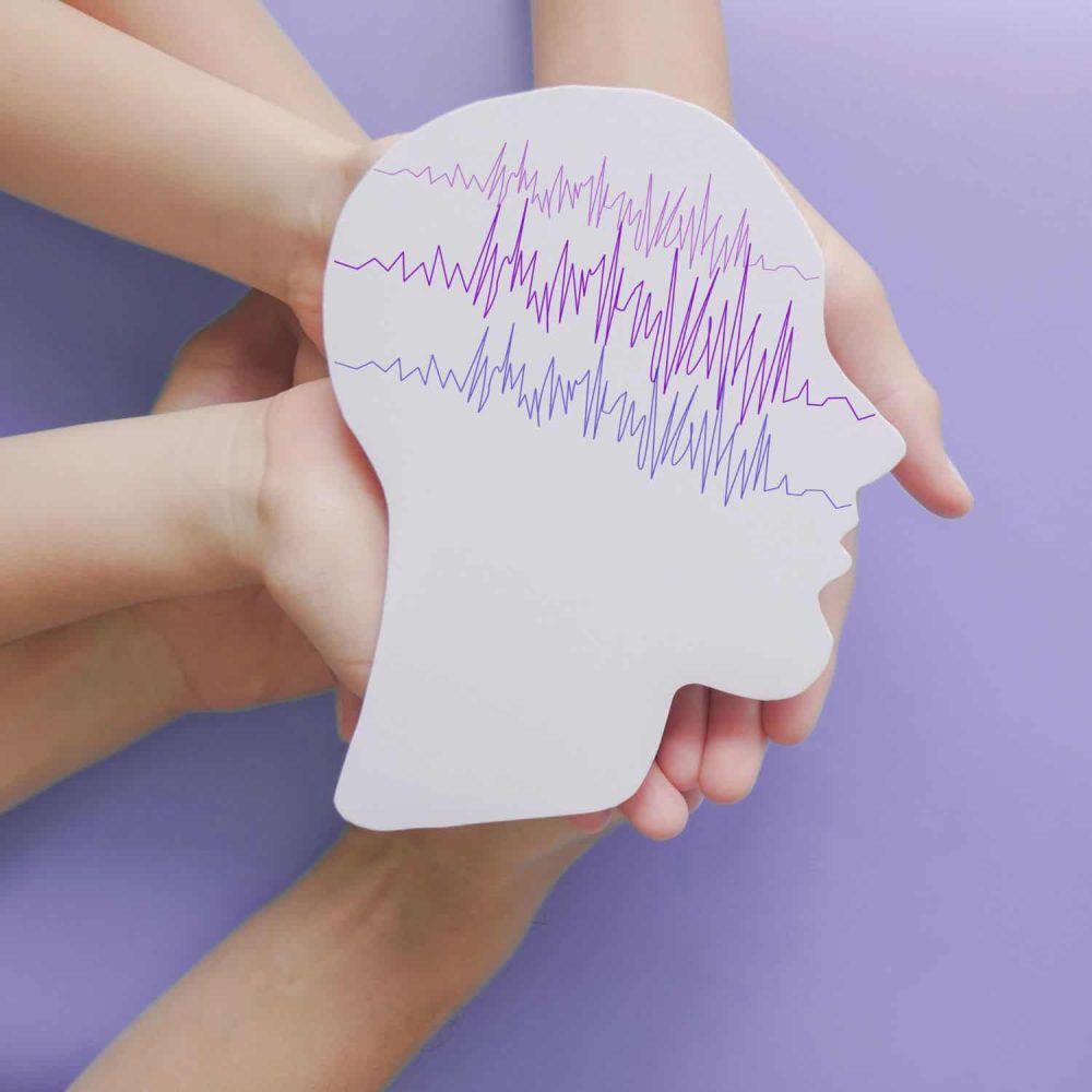 Epilepsy awareness concept with brain wave patterns and human profile.