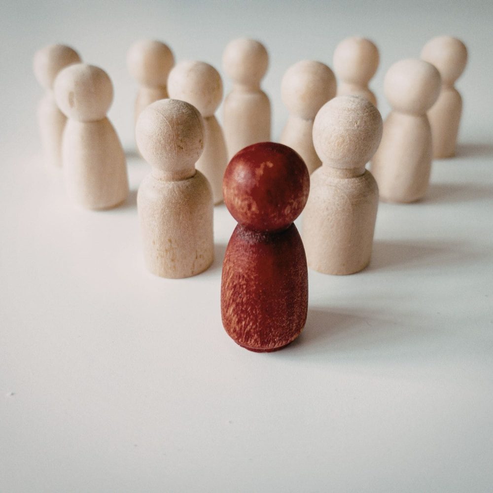 Wooden figurines representing leadership and team dynamics.
