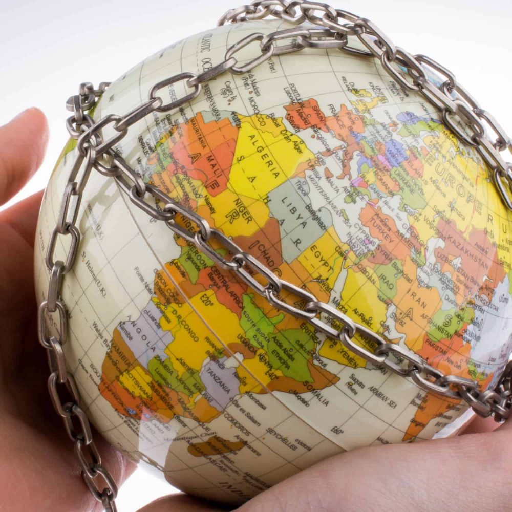 Globe with chains symbolising global slavery and human rights issues.