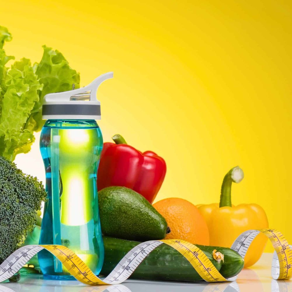 Healthy vegetables and water bottle for hydration training.