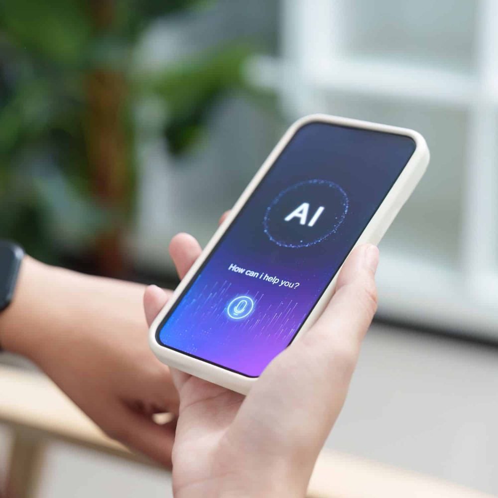 Person holding smartphone displaying AI interface for online training.
