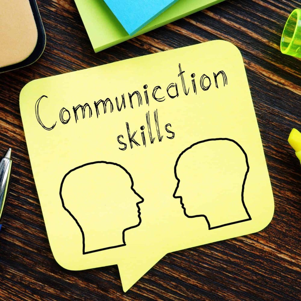 Illustration of two heads with 'Communication skills' text for training course.