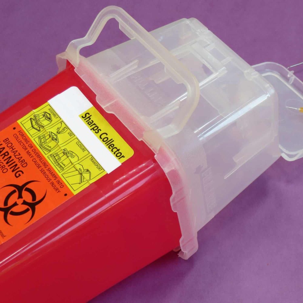 Sharps collector container for safe disposal of needles and syringes.
